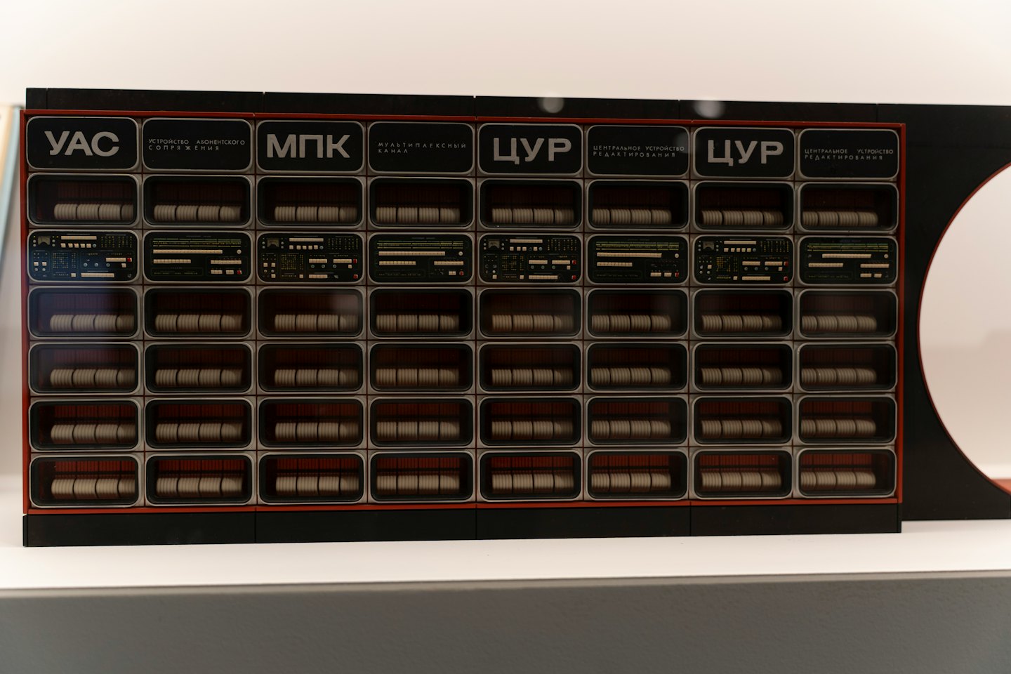 Retro-futuristic computer modules with spools and lights.