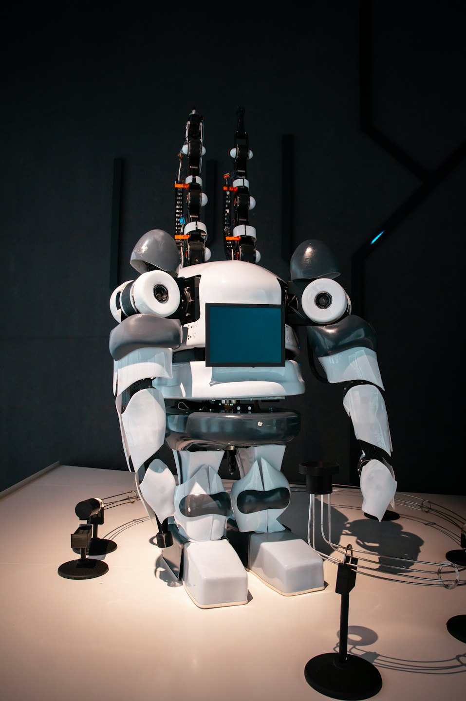 Humanoid robot standing in a modern showroom.